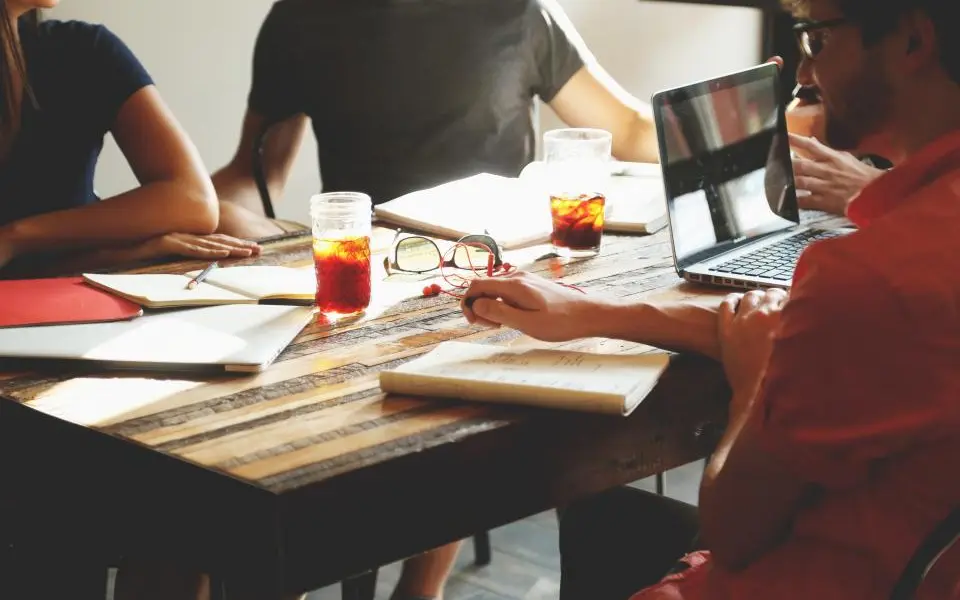 A team working around a table with laptops