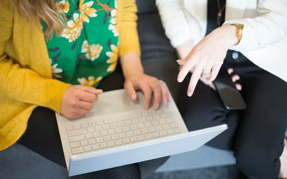 Two people looking at a laptop together